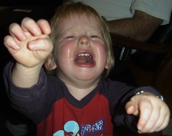 photo of Benjamin crying and reaching for the camera