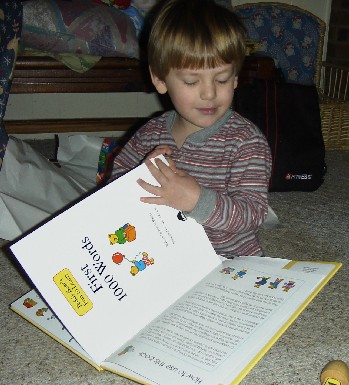 photo of Alex looking at his new book